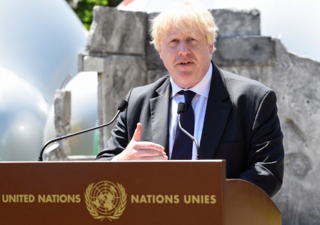 British Foreign Secretary Boris Johnson addresses the audience at an exhibition on girls education in the grounds of the Palais des Nations in Geneva on June 18
