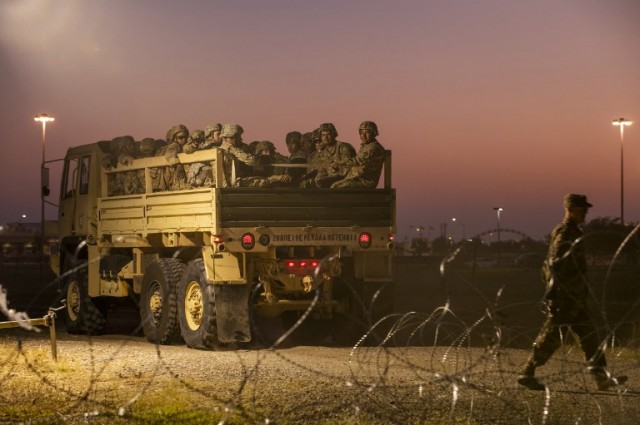 In this file photo taken on November 06, 2018 US Army troops enter a compound where the military is erecting an encampment near the US-Mexico border crossing at Donna, Texas