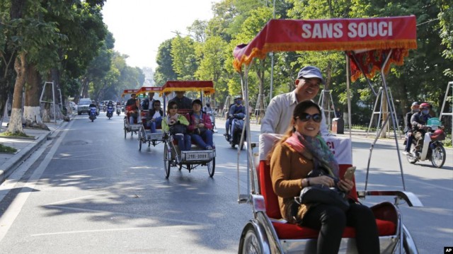 Chinese tourists ride rickshaws for sightseeing in Hanoi, Vietnam, Thursday, Dec. 1, 2016. China tops the list of number of tourists coming to Vietnam. (AP Photo/Tran Van Minh)